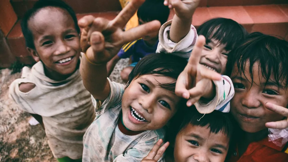 Children in a community, looking towards the camera
